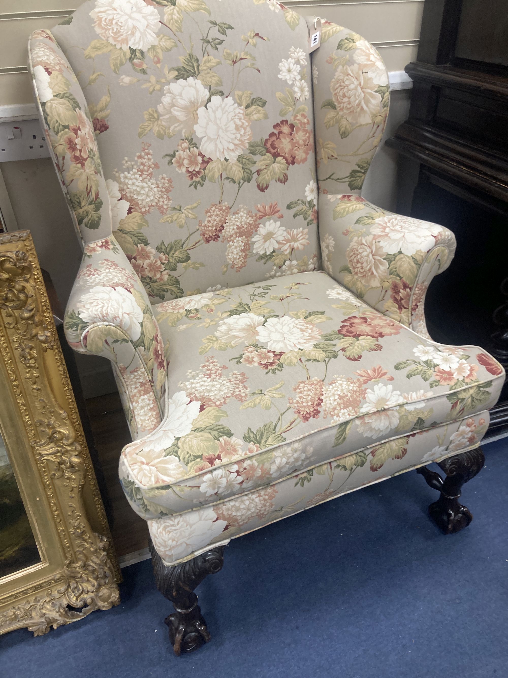 A Chippendale revival wing armchair together with a matching contemporary footstool